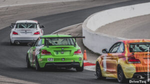Three racing cars at a racing track